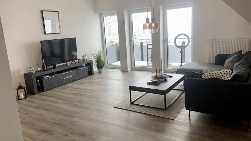 Modern 2.5-Room Loft with Balcony, E-Mobility Parking & Scenic Views